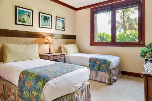 a hotel room with two beds and a window at Popular Ground Floor with Extra Grassy Area - Beach Tower at Ko Olina Beach Villas Resort in Kapolei