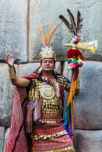 a man dressed in a costume with a trumpet at Cusco Plaza Nazarenas in Cusco