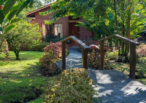 a garden with a wooden stairway leading to a house at Hotel El Silencio del Campo in Fortuna