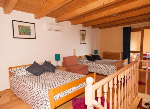 a living room with two beds and a staircase at Villa Visnjan Residence 2 in Višnjan