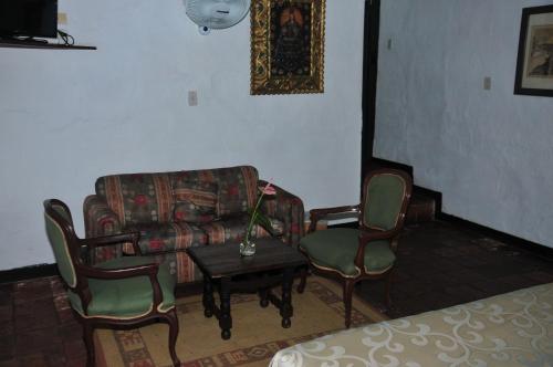 a living room with a couch and chairs and a table at Hotel Mision Santa Barbara RNT 4799 in Barichara