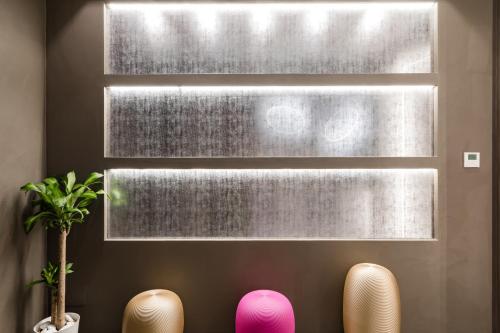 a room with two chairs and a window at A World Aparts - Barberini Boutique Hotel in Rome