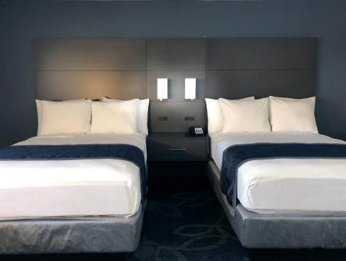two beds in a hotel room with white pillows at The Historic Brookdale Lodge, Santa Cruz Mountains in Brookdale