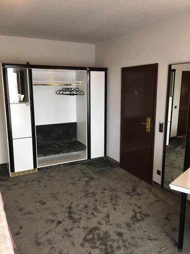an empty room with a large glass door and a room at La Conacul Vesel Săpânța in Săpînţa