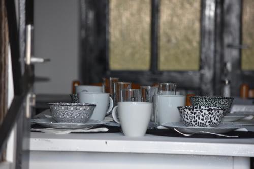 a group of cups and plates on a shelf at Pannonia Terranova in Vardarac