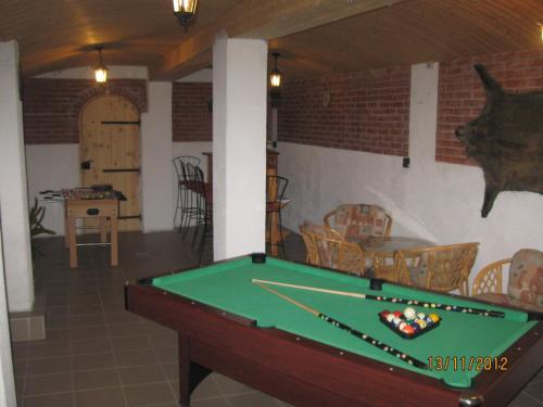a pool table in a living room with a pool table at Attila's Guest House in Budaörs