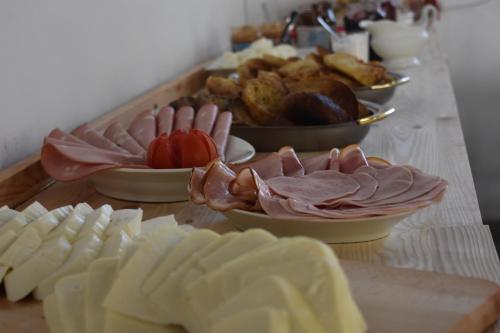a table with plates of food and bowls of food at Pannonia Terranova in Vardarac
