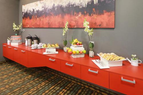 a buffet of fruit on a red cabinet at Wyndham Garden Guadalajara Acueducto in Guadalajara