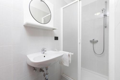 a white bathroom with a sink and a mirror at Holiday Home Sanchi in Labin