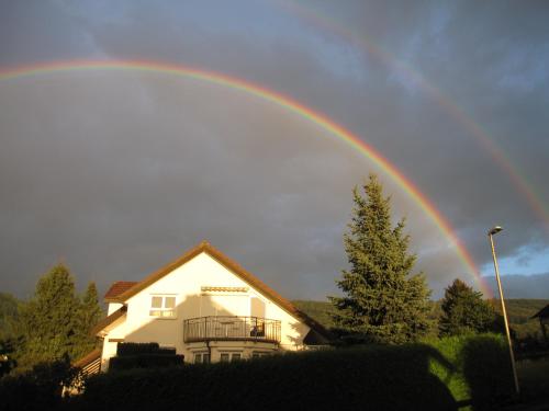 a rainbow over a house with a house at Ferienwohnung Wölfle in Friesenheim