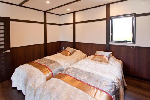 
سرير أو أسرّة في غرفة في Villa Resort Yumefuji
