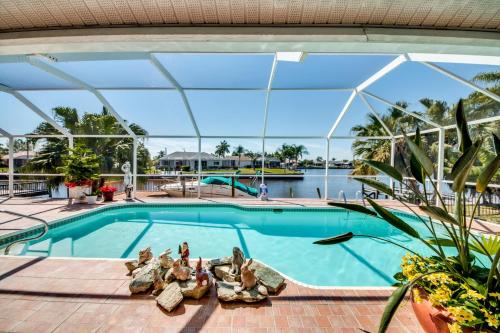 a swimming pool with a view of the water at Villa Sweet Dreams, Cape Coral in Cape Coral