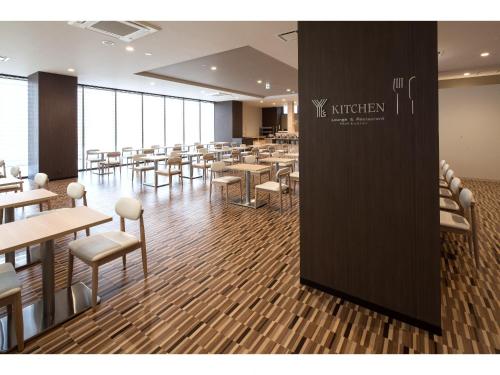 a large dining room with tables and chairs at Y's Hotel Asahikawa Ekimae in Asahikawa