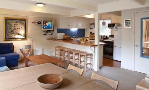 a kitchen and living room with a table and a kitchen and a kitchen at Maisonette, Falls Creek in Falls Creek