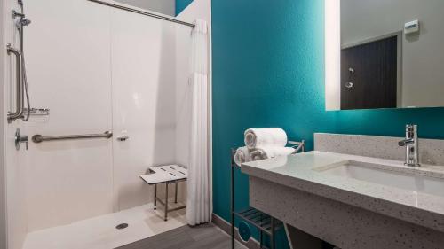 La salle de bains est pourvue d'une baignoire, d'un lavabo et d'une douche. dans l'établissement Best Western Plus Ruston Hotel, à Ruston