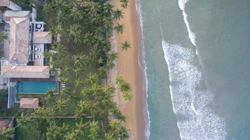 an overhead view of a beach with palm trees and the ocean at The Villa by Contemporary Ceylon in Wadduwa