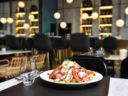 a plate of food on a table in a restaurant at ibis Styles Dijon Central in Dijon