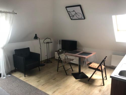 a room with a table and a chair and a desk at Villa Mona Lisa in Hévíz