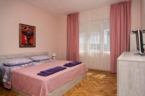 a bedroom with a bed and a television in it at Horizon Apartment in Varna City