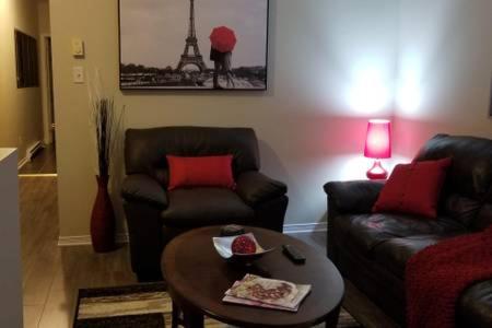 a living room with two couches and a coffee table at Sweet 2-Bedroom Penthouse Apartment by Amazing Property Rentals in Gatineau