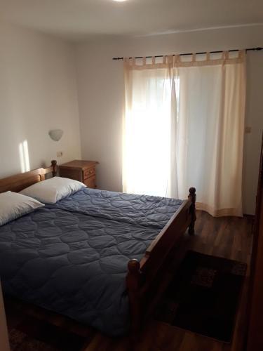 A bed or beds in a room at Apartment and Rooms Hacienda Stelio