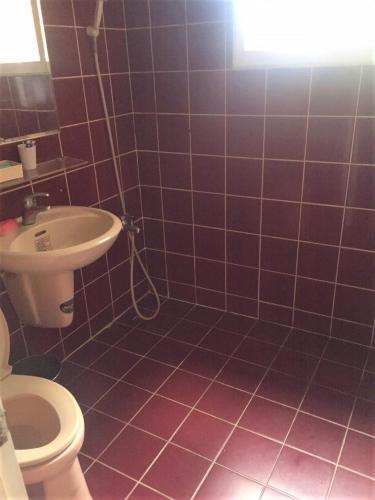 a bathroom with a toilet and a sink at Rich Zone Hotel in Taipei