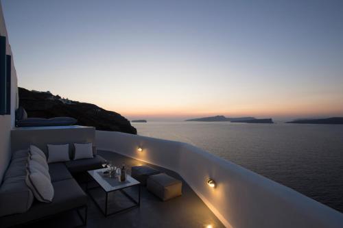 a balcony with a couch and a view of the ocean at Akrotiri Cove in Akrotiri