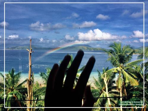 a hand in front of a view of a rainbow at LCF - BB Hotel in Romblon