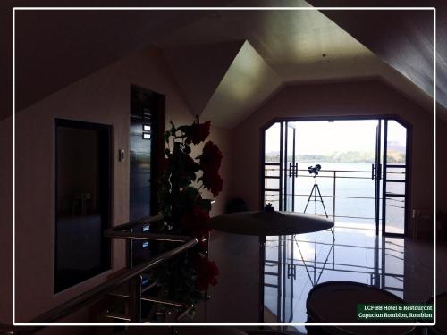 a room with a staircase and a large window at LCF - BB Hotel in Romblon