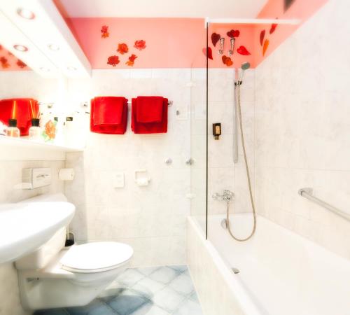 a bathroom with a shower and a toilet and a sink at Hotel Azenberg in Stuttgart
