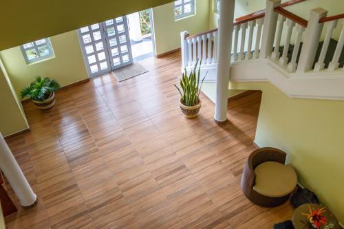 an empty house with a staircase and potted plants at Captain's Villa in Takamaka
