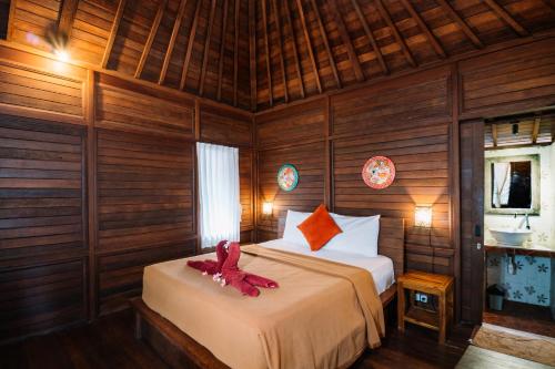 Giường trong phòng chung tại Bunda 7 Bungalows