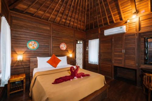 Giường trong phòng chung tại Bunda 7 Bungalows