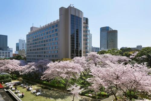 a city skyline withakura trees in front of a building at The Prince Sakura Tower Tokyo, Autograph Collection in Tokyo