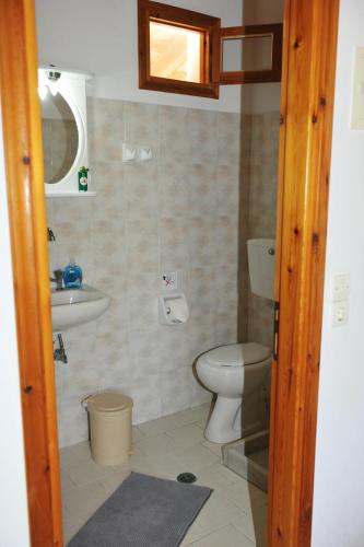 a bathroom with a toilet and a sink at Petros Giatras - Rooms in Zakynthos Town