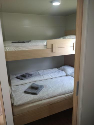 two bunk beds in a small room with at Mobile Homes Krko Pirovac in Pirovac