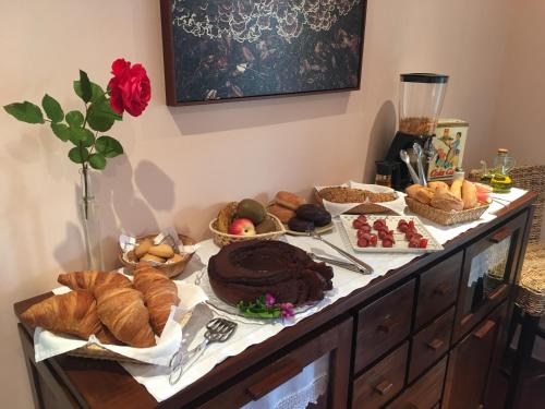 a table with various types of bread and pastries on it at Hotel Rural El Texeu in Llanes