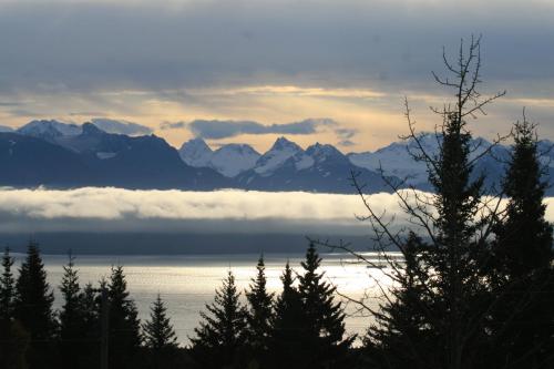 a view of a mountain range with clouds in the water at Halcyon Heights B&B/Inn in Homer