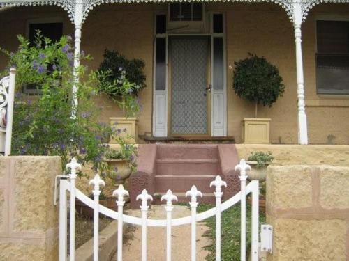 a white fence in front of a house at Amalie Cottage Waikerie Unit 1 in Waikerie
