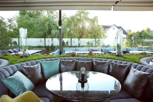 a couch with a table on a patio at Kolyada Hotel in Odesa