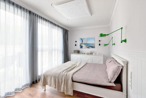 Łóżko lub łóżka w pokoju w obiekcie Orłowska Riviera