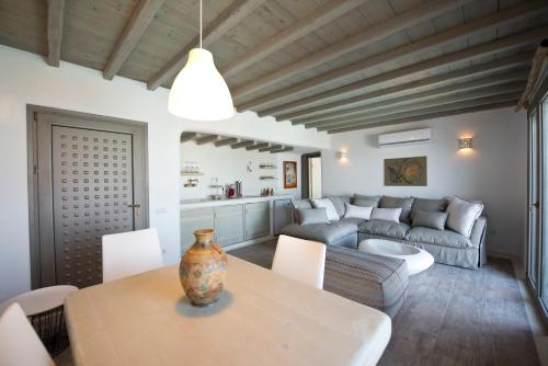 a living room with a table and a couch at Amallini Suites Mykonos in Super Paradise Beach