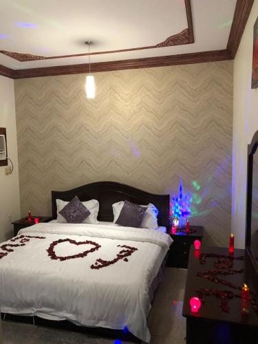 a bedroom with a bed with a heart drawn on it at Beyoot Alsharq Furnished Units in Al Khobar