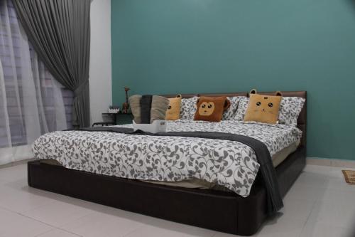 a bed with pillows on it in a bedroom at Luxury Kuala Selangor Homestay in Kuala Selangor
