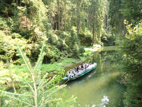 a group of people in a boat on a river at Fewo Hoyer in Hinterhermsdorf