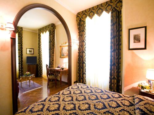 Кровать или кровати в номере Hotel Vittoria