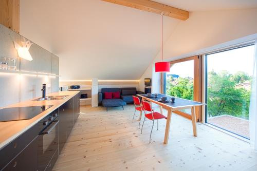 a kitchen with a table and a dining room at Zeitraumferien in Bernau am Chiemsee