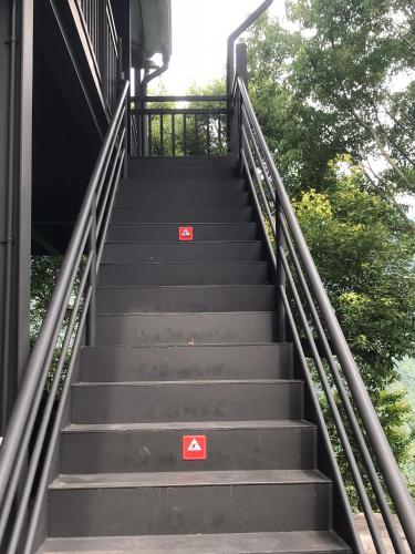 a set of stairs with two red signs on them at SuWaNa in Leye