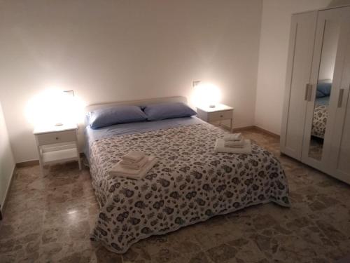 a bedroom with a bed with two night stands and two lamps at Villa Iavernaro in Pulsano
