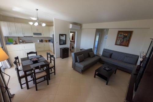 a living room with a couch and a table at Grand Suites with Private Pools in Kalamata